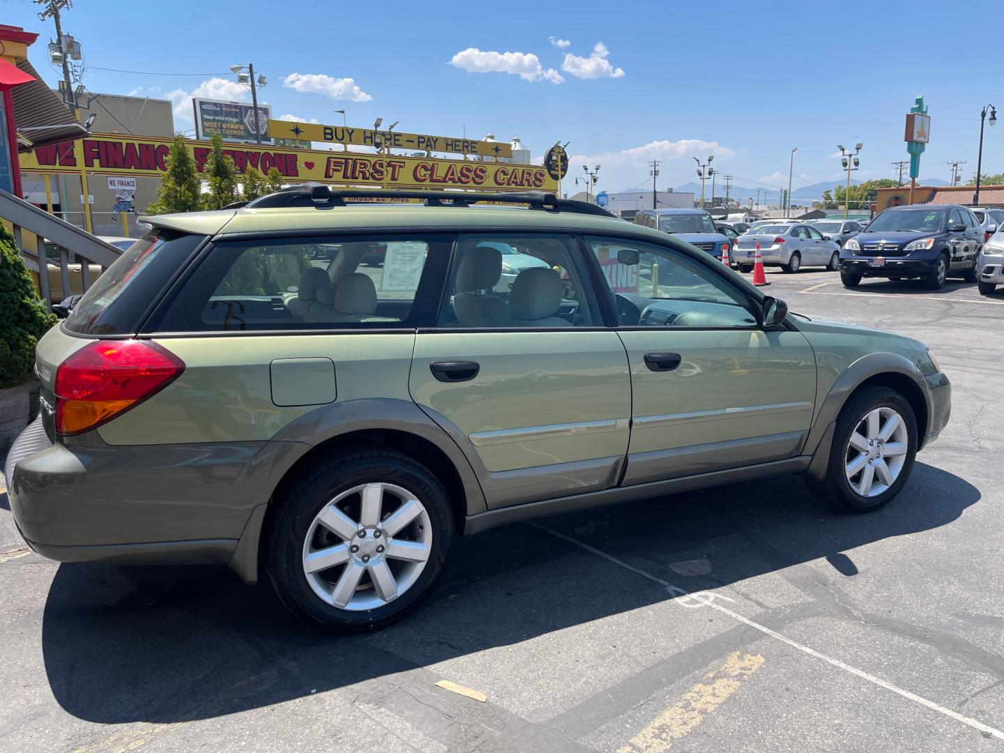 2007 Evergreen Frost Metallic /Tan Subaru Outback Crossover Wagon (4S4BP61CX77) with an 2.5L H4 engine, Automatic transmission, located at 801 South State Street, Salt Lake City, UT, 84111, (801) 328-0098, 40.751953, -111.888206 - Features: 4WD/AWD, Alloy Wheels, Cloth Seats, Front Seat Heaters, ABS Brakes, Auxiliary Audio Input, Overhead Airbags, Rear Defroster, AM/FM Stereo, CD Audio, Power Locks, Side Airbags, Air Conditioning, Cruise Control, Power Mirrors, Automatic Transmission, Full Roof Rack, Power Windows. - Photo#6