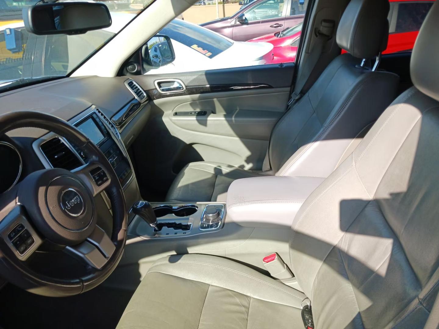 2012 Black /Tan Jeep Grand Cherokee Laredo 4WD (1C4RJFAG9CC) with an 3.6L V6 DOHC 24V engine, 5-Speed Automatic transmission, located at 801 South State Street, Salt Lake City, UT, 84111, (801) 328-0098, 40.751953, -111.888206 - Clean title! Clean car inside and out this vehicle looks immaculate! A must see for anyone looking for a nice Jeep! Vehicle is 4x4 great for winter and all season weather! All around clean SUV hard to find in this price range this clean! Features: 4WD/AWD, Leather Seats, Alloy Wheels, Navigation S - Photo#4