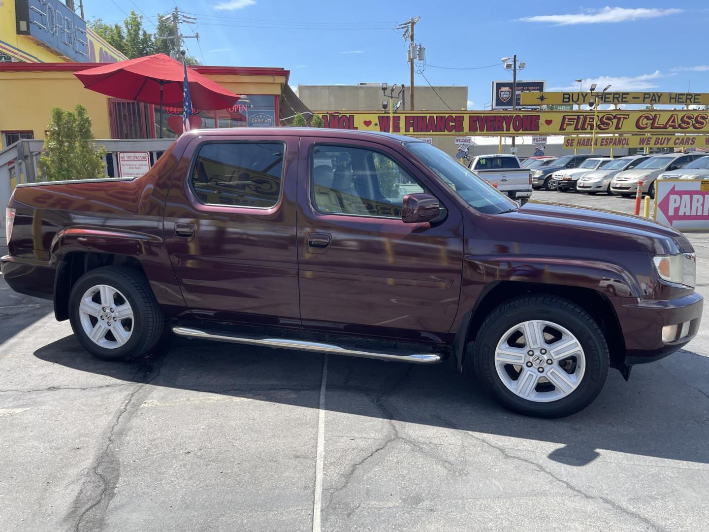 2013 Maroon /Tan Honda Ridgeline RTL w/ Leather and Navigation (5FPYK1F53DB) with an 3.5L V6 SOHC 24V engine, 5-Speed Automatic transmission, located at 801 South State Street, Salt Lake City, UT, 84111, (801) 328-0098, 40.751953, -111.888206 - Clean title! 4x4 in great condition! Bed liner is brand new and looks great we had a new bed liner installed! Truck has been through our mechanic shop and passed emissions already and approved for up to a 3 month to 5 year warranty that can be purchased! Very nice truck for anyone looking for a Ridg - Photo#5