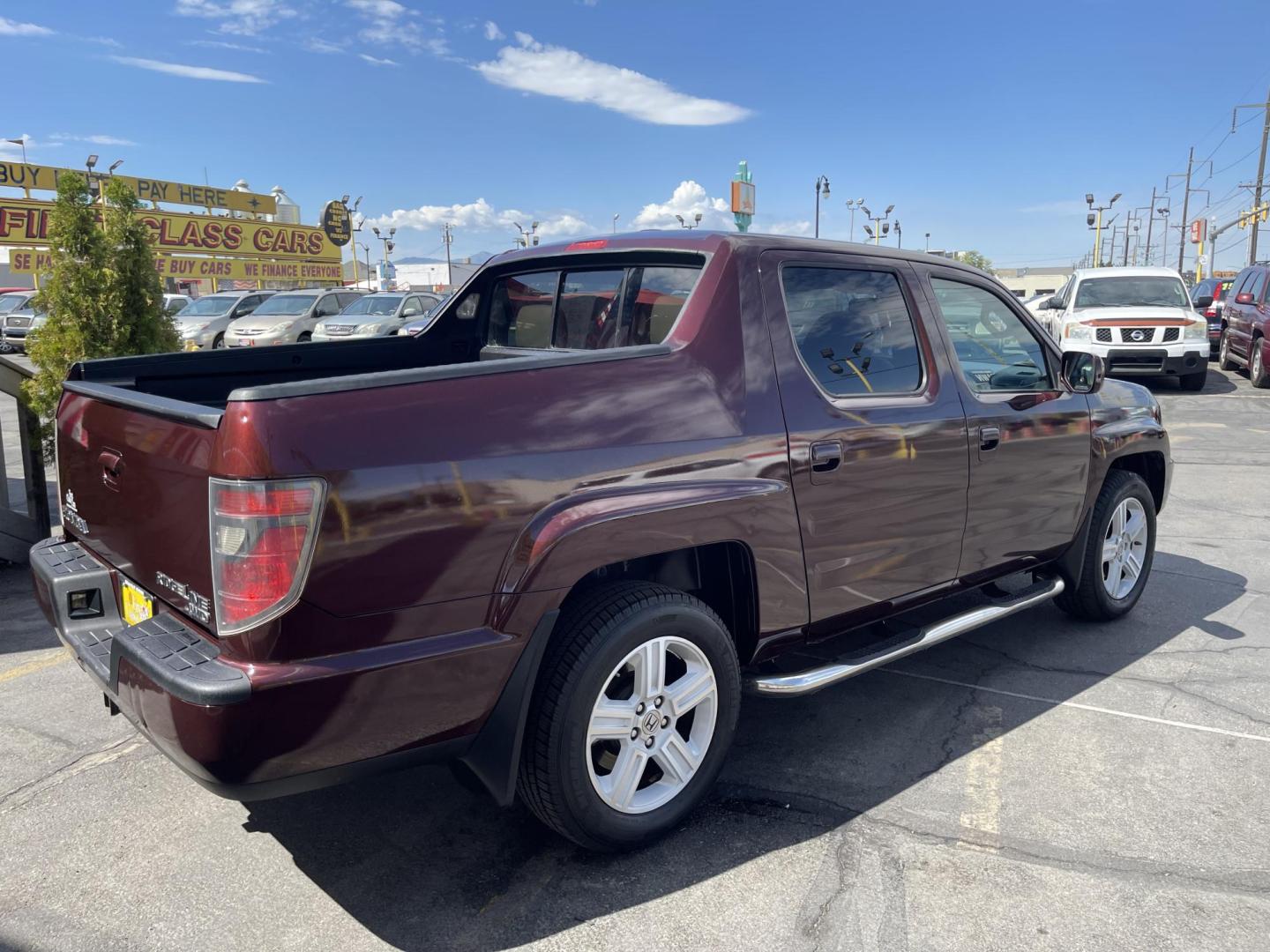 2013 Maroon /Tan Honda Ridgeline RTL w/ Leather and Navigation (5FPYK1F53DB) with an 3.5L V6 SOHC 24V engine, 5-Speed Automatic transmission, located at 801 South State Street, Salt Lake City, UT, 84111, (801) 328-0098, 40.751953, -111.888206 - Clean title! 4x4 in great condition! Bed liner is brand new and looks great we had a new bed liner installed! Truck has been through our mechanic shop and passed emissions already and approved for up to a 3 month to 5 year warranty that can be purchased! Very nice truck for anyone looking for a Ridg - Photo#7