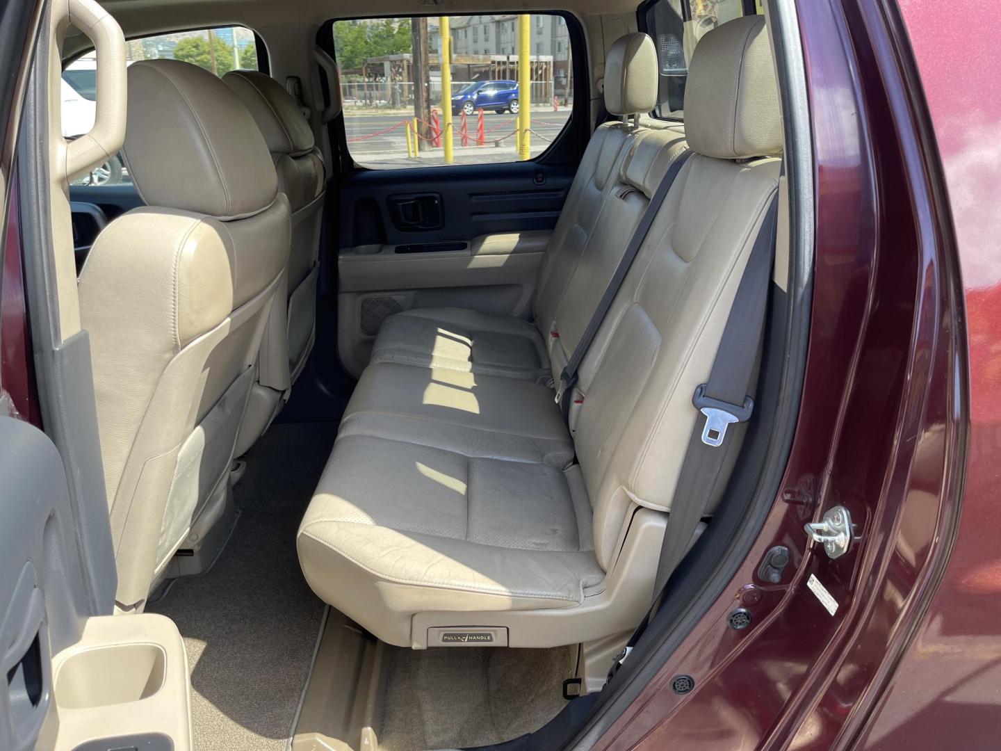 2013 Maroon /Tan Honda Ridgeline RTL w/ Leather and Navigation (5FPYK1F53DB) with an 3.5L V6 SOHC 24V engine, 5-Speed Automatic transmission, located at 801 South State Street, Salt Lake City, UT, 84111, (801) 328-0098, 40.751953, -111.888206 - Clean title! 4x4 in great condition! Bed liner is brand new and looks great we had a new bed liner installed! Truck has been through our mechanic shop and passed emissions already and approved for up to a 3 month to 5 year warranty that can be purchased! Very nice truck for anyone looking for a Ridg - Photo#15