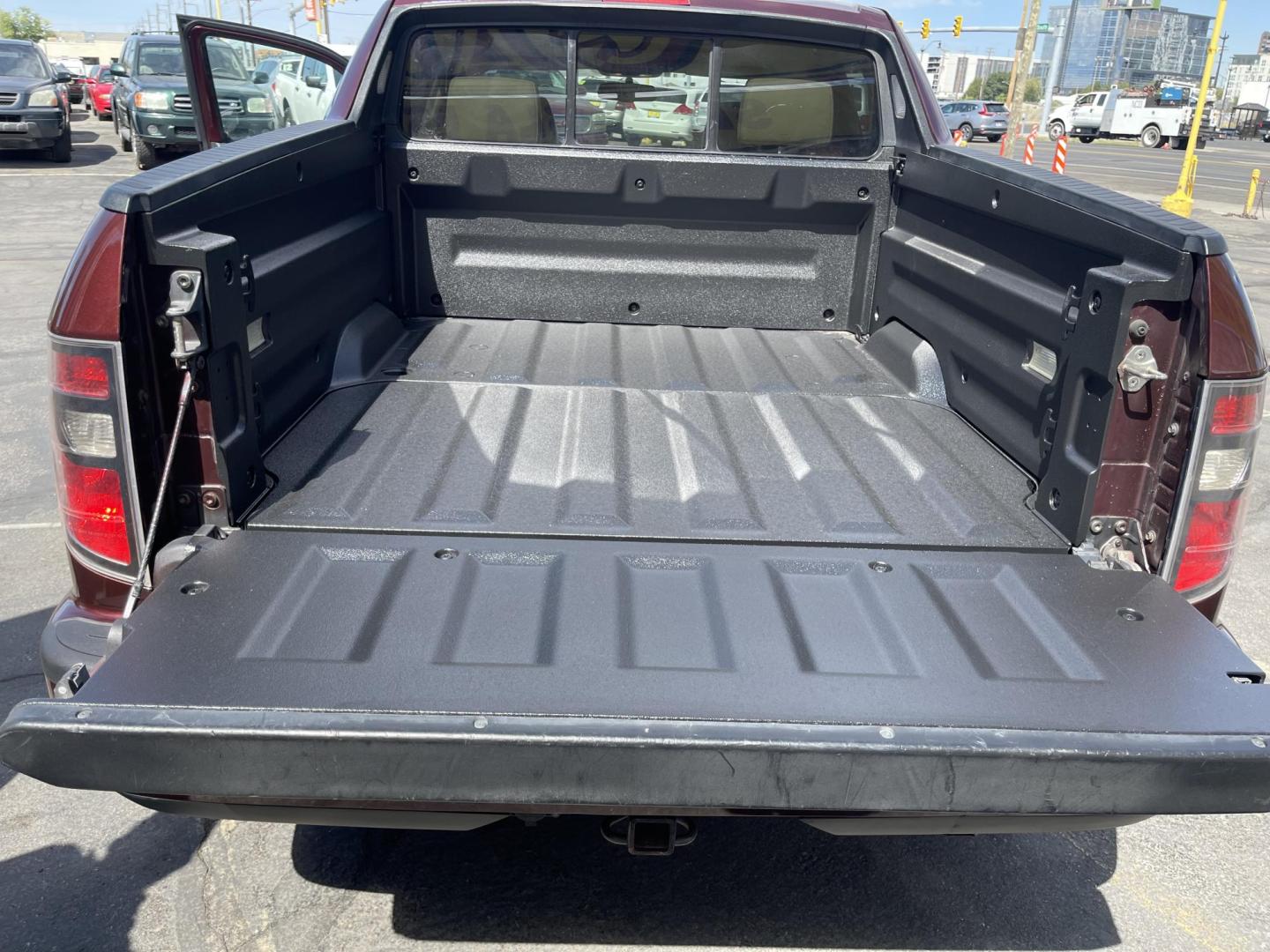 2013 Maroon /Tan Honda Ridgeline RTL w/ Leather and Navigation (5FPYK1F53DB) with an 3.5L V6 SOHC 24V engine, 5-Speed Automatic transmission, located at 801 South State Street, Salt Lake City, UT, 84111, (801) 328-0098, 40.751953, -111.888206 - Clean title! 4x4 in great condition! Bed liner is brand new and looks great we had a new bed liner installed! Truck has been through our mechanic shop and passed emissions already and approved for up to a 3 month to 5 year warranty that can be purchased! Very nice truck for anyone looking for a Ridg - Photo#23