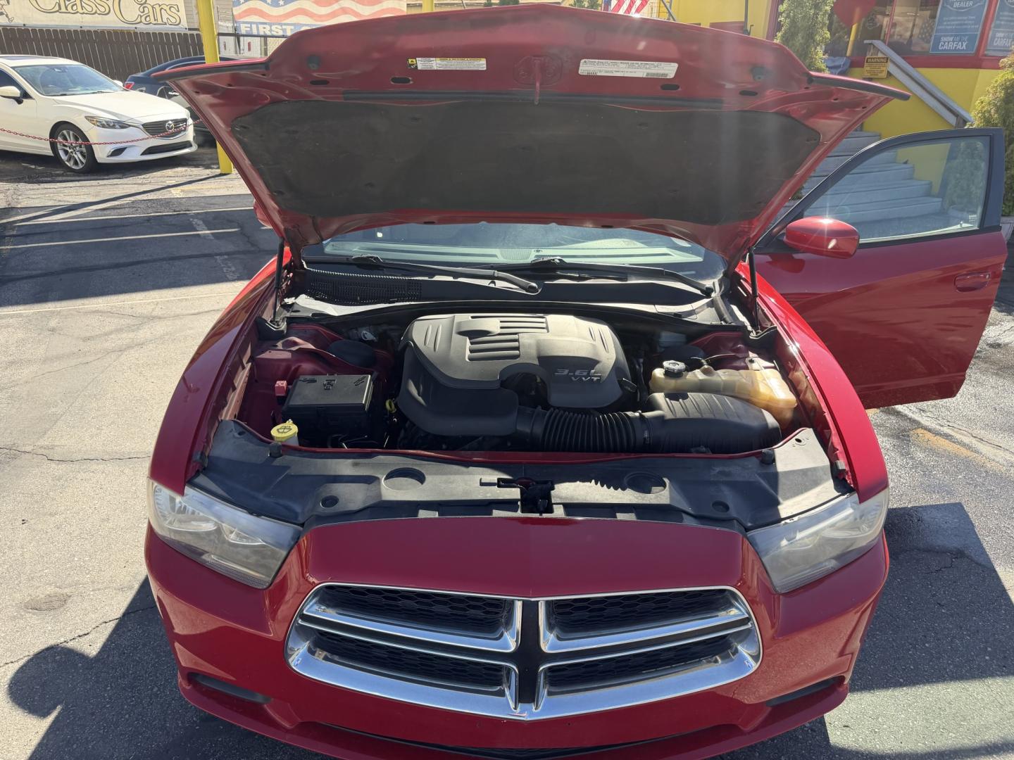 2012 Flame Red /Tan Dodge Charger SE (2C3CDXBG5CH) with an 3.6L V6 DOHC 24V engine, 5-Speed Automatic transmission, located at 801 South State Street, Salt Lake City, UT, 84111, (801) 328-0098, 40.751953, -111.888206 - Clean title! Carfax shows this vehicle has been meticulously cared for and maintained Carfax shows regular service was done and oil changes. This vehicle has passed all mechanical inspections and approved for up to a 5 year warranty that can be added at time of purchase! Features: Automatic, Alloy- Photo#23